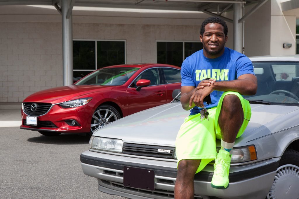 Alfred Morris Sitting on His 1991 Mazda 626