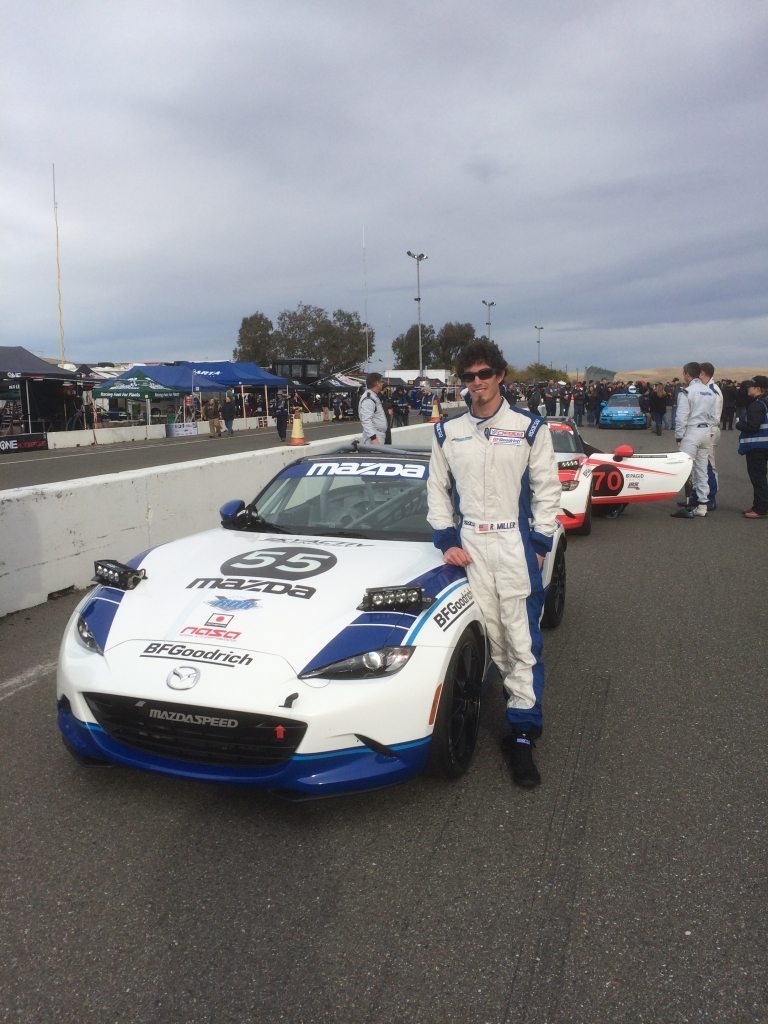 Mazda Motorsports Engineer Randy Miller standing in front of a Mazda racing car