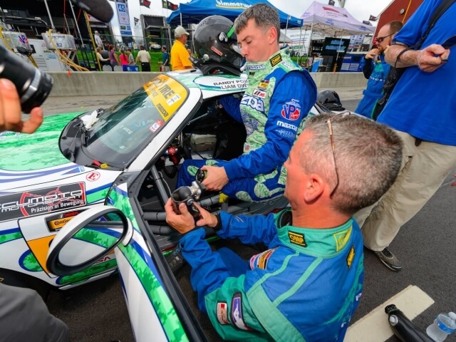 Mazda Motorsports RacerLiam Dwyer Getting into the Race Car